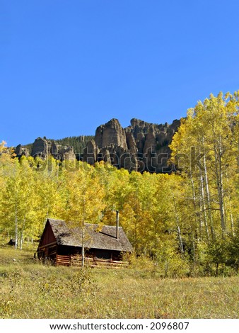 Old cabin tucked away in an aspen grove in the Colorado mountains