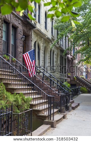 Stairway with an American flag by the brownstone houses in urban residential neighborhood of Brooklyn, NYC.