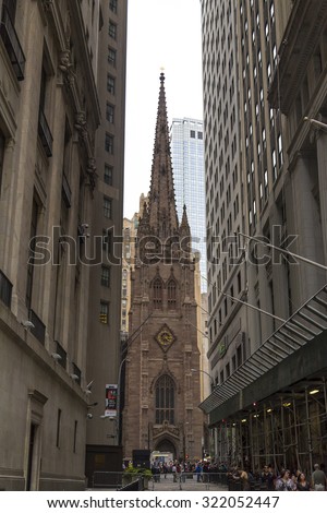 NEW YORK CITY - AUGUST 30, 2014: Trinity Church at the intersection of Wall street and Broadway in Manhattan, NYC
