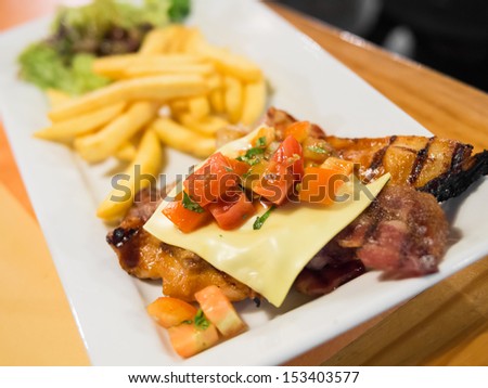 Grilled chicken steak, French fries and vegetables