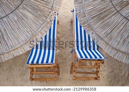 Similar – Image, Stock Photo two straw beach umbrellas on an empty seashore on a clear day