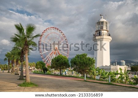 Batumi promenade with Ferris wheel and old lighthouse, Georgia. Summer view of the Batumi city waterfront, resort town of Georgia Сток-фото © 