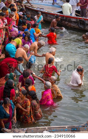 VARANASI, INDIA - MARCH 21: Hindu pilgrims take holy bath in the river ganges on the auspicious Maha Shivaratri festival on March 21, 2013 in Varanasi, Uttar Pradesh, India