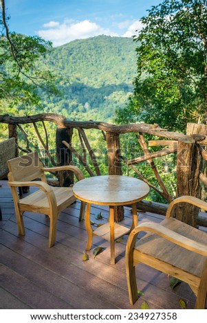 Wooden table and chairs in the cafe with a wonderful mountain view. Northern Thailand.