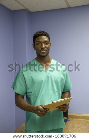 vertical, color image of an african american doctor reading charts