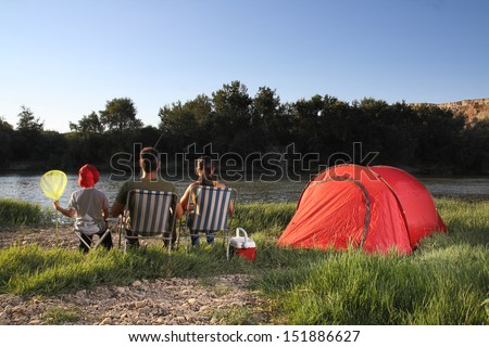 Family camping in river