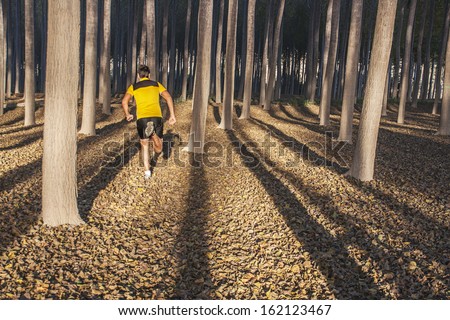 man running through forest