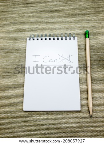 the word can't written  in pencil on a spiral bound note pad with the T crossed out to make can