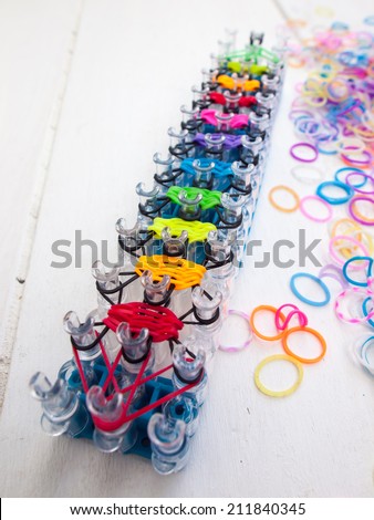 band loom and colorful elastic bands against a white table top