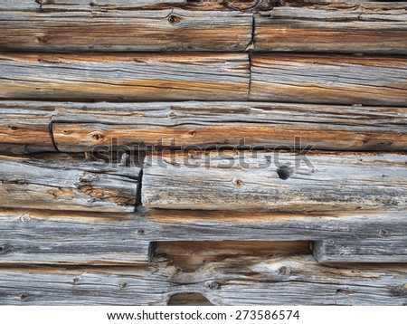 detail of cabin wall of weathered grayed logs for background
