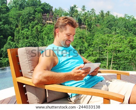 happy man with white tablet device