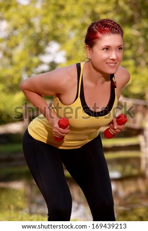 Young Woman Aerobics Instructor with set of weights 2