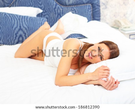 beautiful pretty cute girl lounging on the bed in the bad room 7