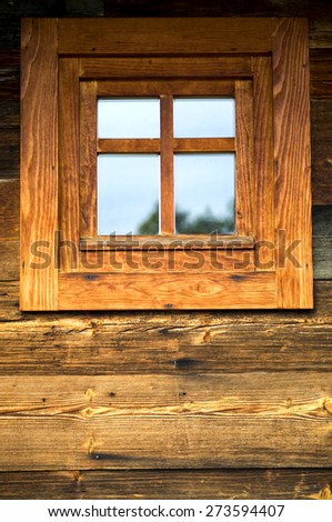 Wooden window on the wall of an old wooden house