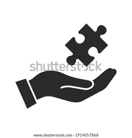 Puzzle icon. Puzzle piece in hand. Vector icon isolated on white background.