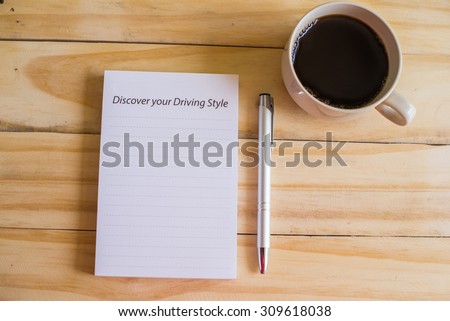 notebook pen and cup of coffee in wood table