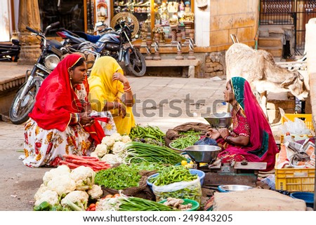 Jaisalmer, India- February25,2013: Woman with ethnic costume selling the vegetables in Jaisalmer bazaar on  in Jaisalmer,India
