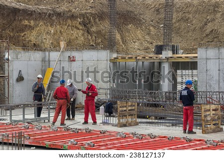 BELGRADE, SERBIA - NOVEMBER 11: Workers and concrete rebar: Installation of steel for a suspended slab. Selective focus. At construction site in November 2014.