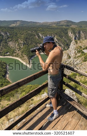 Photographer captures pictures of griffon vultures from the viewpoint Molitva. Photographer working in nature Reserve Uvac - Serbia. Made with selective focus and and shallow dof.