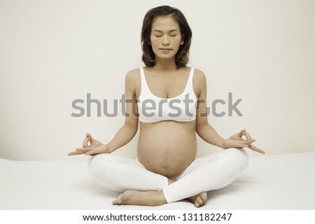 Pregnant woman doing yoga exercises for the stomach stronger