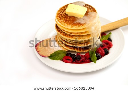 Mixed berry pancake on white plate.
