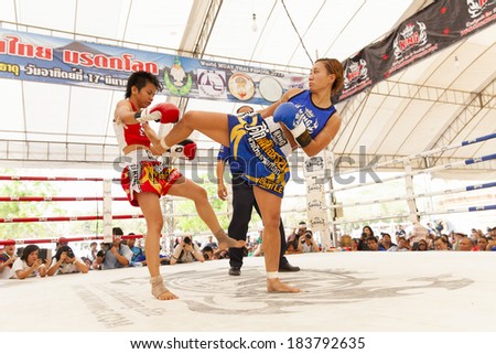 AYUTTHAYA, THAILAND- MARCH 17 : Women Thai boxing match between  Yordying SithMuaySiam (Thai) VS Little Tiger (Japan) at World Muay Thai Fight Fastival on March 17, 2013 in Ayutthaya, Thailand.