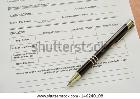 A job application jobs sitting with a pen, applying for a job