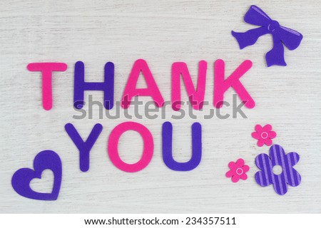 Thank you written with colorful letters on white wood