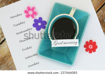Good morning card with cup of tea and days of the week listed on white paper