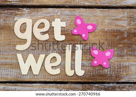Get well written with wooden letters on rustic wooden surface