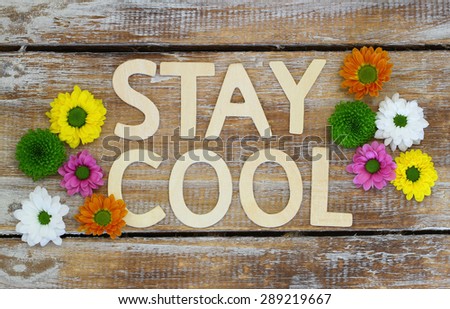 Stay cool written with wooden letters and Santini flowers
