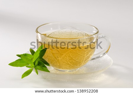 Lemon verbena Herbal Tea in a glass cup. Aloysia citriodora.  Naturopathy. White Background.