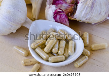 Garlic extract capsules. Dietary supplements. Selective focus. Taken in daylight.