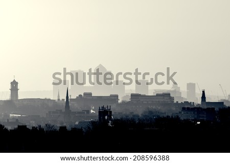 Gotham Retro Photo Filter - London Cityscape at Sunrise with early morning mist from Hampstead Heath looking towards Canary Wharf, England, UK