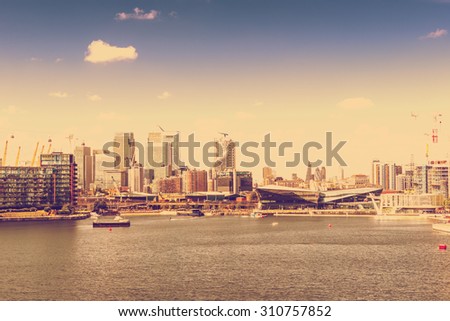RETRO PHOTO FILTER EFFECT: View of the City of London and Isle of Dogs from The Victoria Docks, London, England, UK
