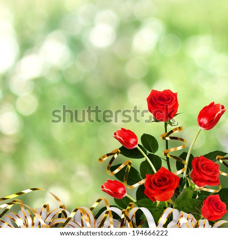Bouquet of red roses and tulips with green leaves and ribbons on the abstract background with bokeh effect