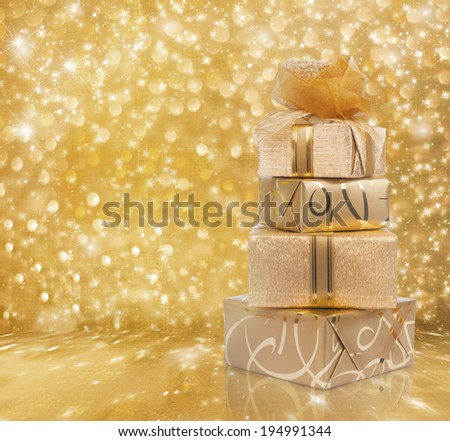 Beautiful gift boxes in gold paper with a silk rose on abstract background
