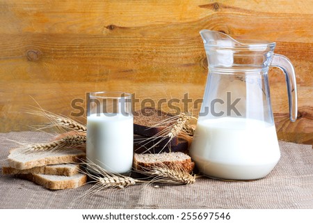 Bread from rye and wheat flour of rough grinding and glass of fresh cow\'s milk