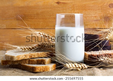 Bread from rye and wheat flour of rough grinding and glass of fresh cow\'s milk