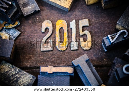 The year 2015 written in rusted metal letters surrounded by vintage wooden and metal letterpress type.