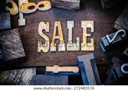 The word SALE written in rusted metal letters surrounded by vintage wooden and metal letterpress type.