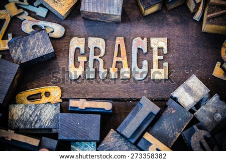 The word GRACE written in rusted metal letters surrounded by vintage wooden and metal letterpress type.