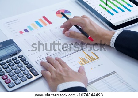 Businessman is deeply reviewing a financial report for a return on investment or investment risk analysis. Photo stock © 