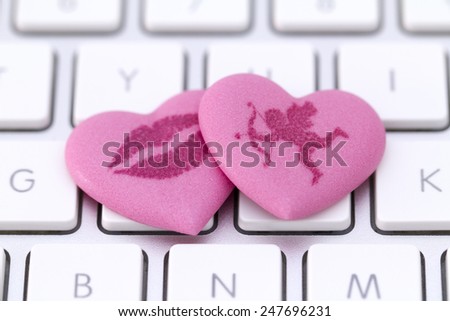Pink candy hearts on a computer keyboard
