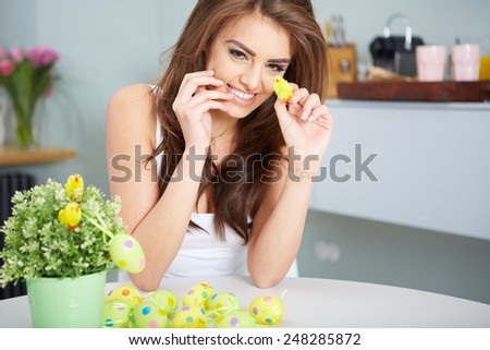 a smiling female laughing with colorful easter eggs
