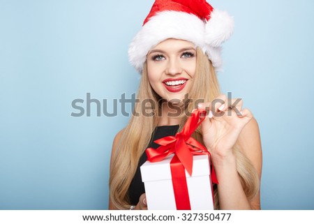 Christmas santa woman with a gift box.