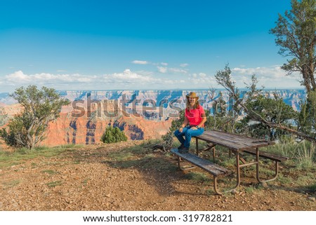 Woman sitting on Picnic Table at The Grand Caynon