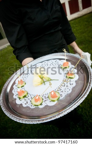 waiter serving food during a catered event