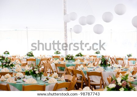 A tent set for dining during an event