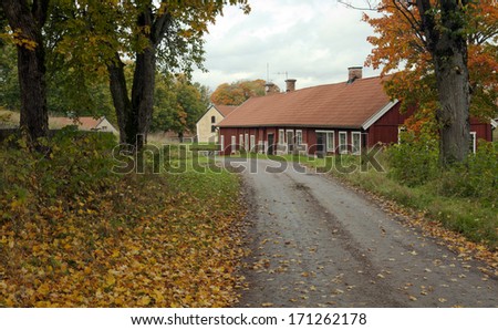Elderly buildings along a gravel road. Environment in earth tune colors.
